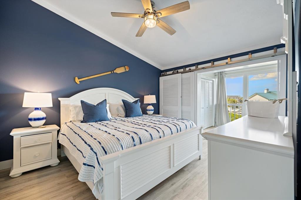 841 Waterside Drive, Unit 202 Venice, FL 34285 - Photo 29 of 43 a bedroom with a bed and a chandelier