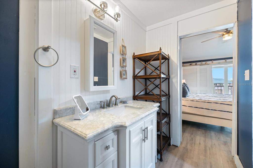 841 Waterside Drive, Unit 202 Venice, FL 34285 - Photo 32 of 43 a bathroom with a granite countertop sink and a mirror