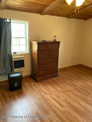 a bedroom with furniture and a flat screen tv