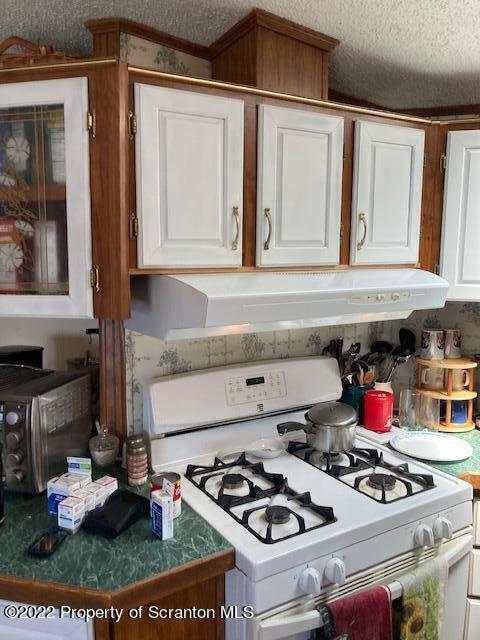 431 Gontarski Road Hallstead, PA 18822 - Photo 7 of 18 a kitchen with a stove and wooden floor