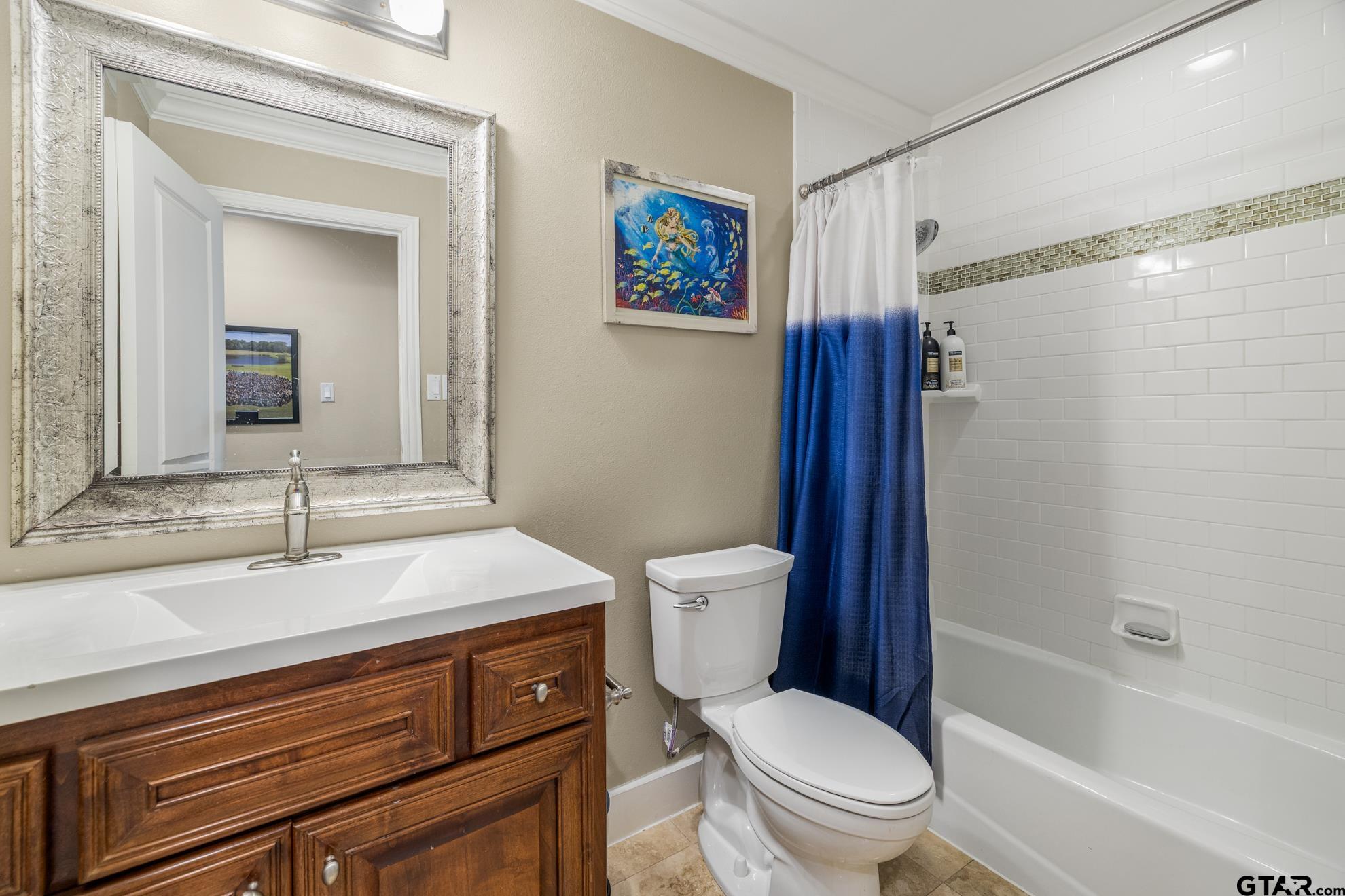 9453 Cherokee Trail Tyler, TX 75703 - Photo 32 of 40 a bathroom with a sink toilet vanity and shower