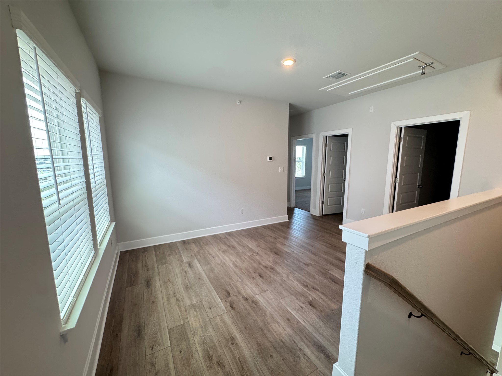 3000 Chisholm Trail Road, Unit 23 Round Rock, TX 78681 - Photo 11 of 26 Natural light filters into this versatile bonus room, offering wood flooring and easy access to other areas of the home.