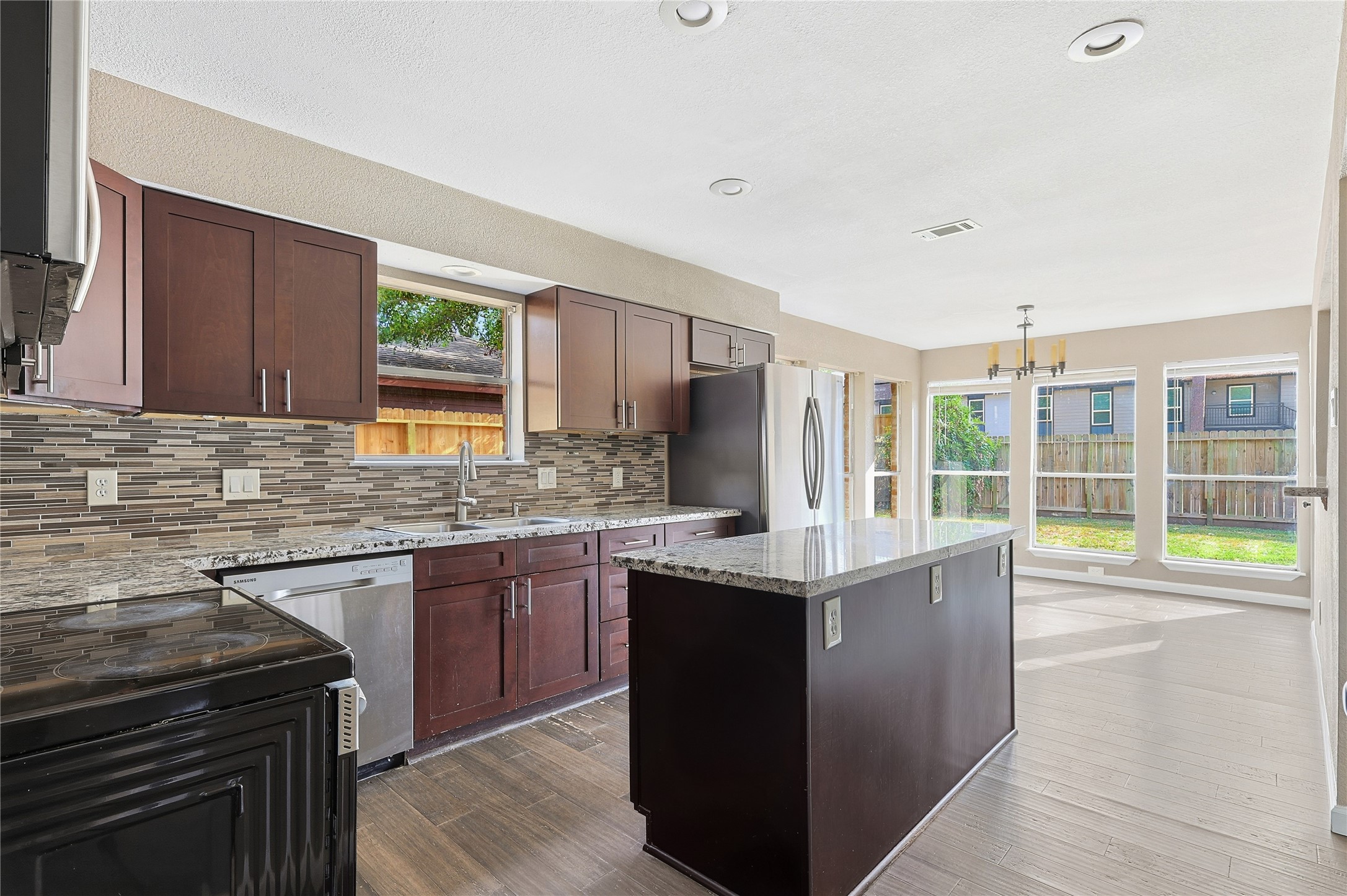 11727 Gardenglen Drive Cypress, TX 77429 - Photo 15 of 38 a kitchen with stainless steel appliances granite countertop a sink stove and refrigerator