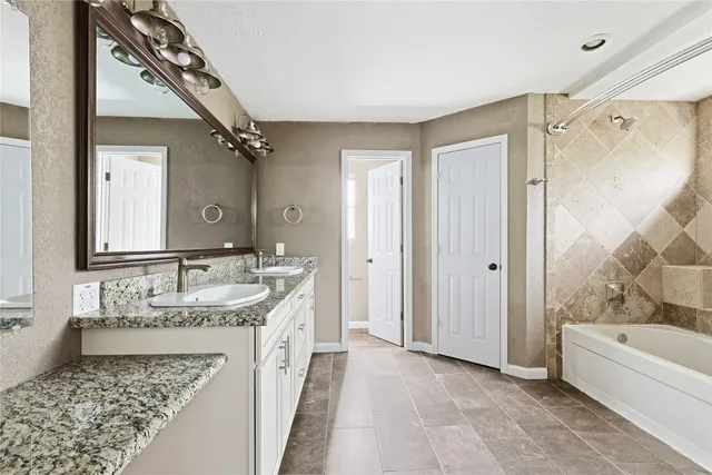 a bathroom with a tub and shower