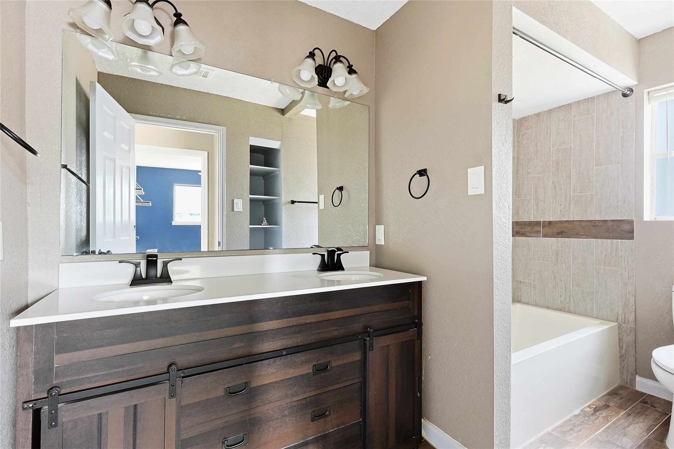 11727 Gardenglen Drive Cypress, TX 77429 - Photo 26 of 38 a bathroom with a bathtub a sink and a mirror