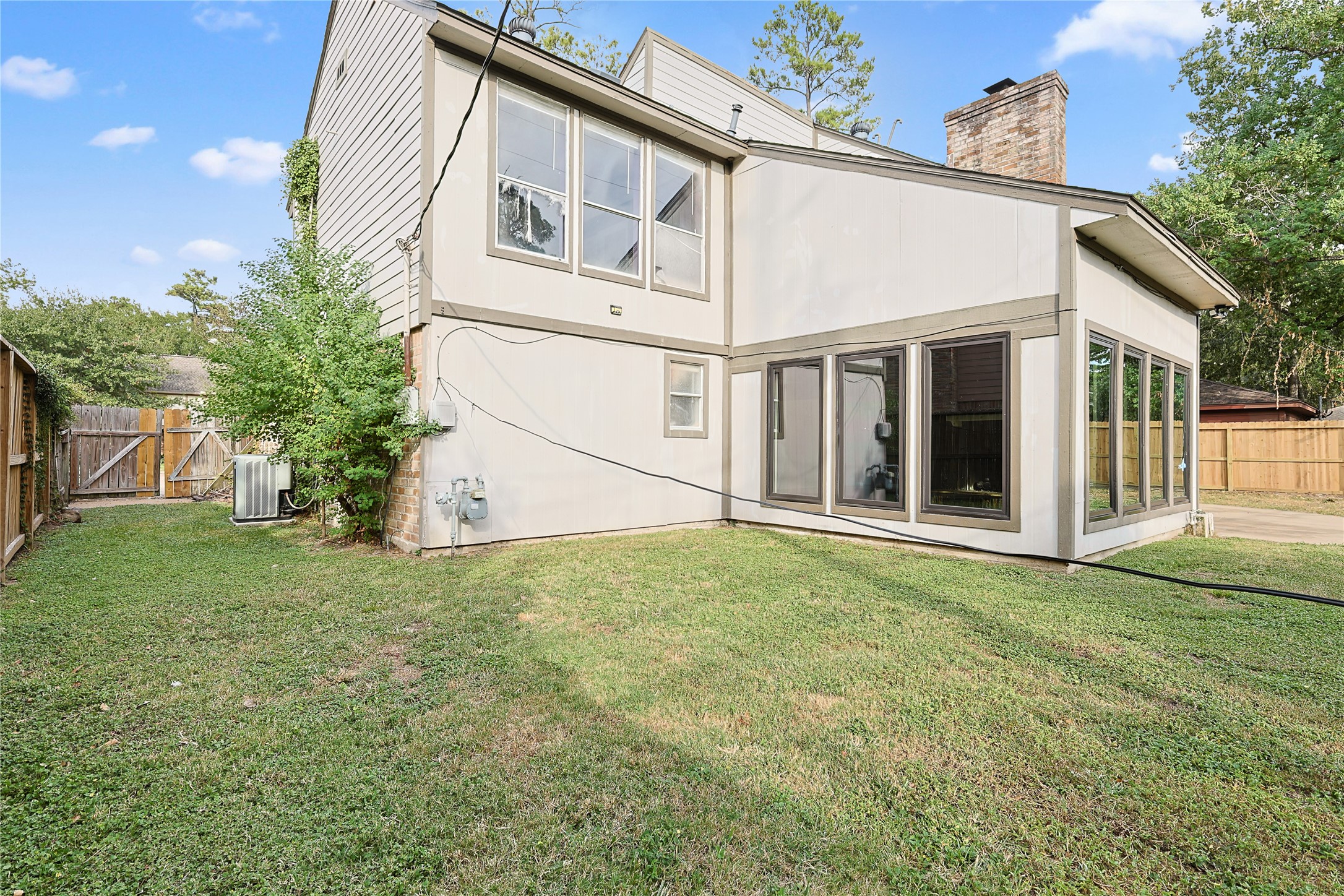 11727 Gardenglen Drive Cypress, TX 77429 - Photo 34 of 38 a view of a white house with a big yard and large trees
