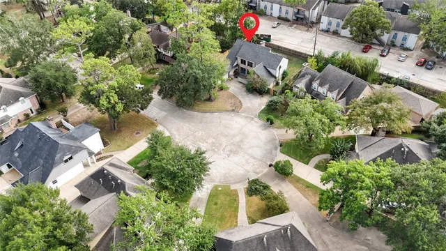 an aerial view of a house with yard