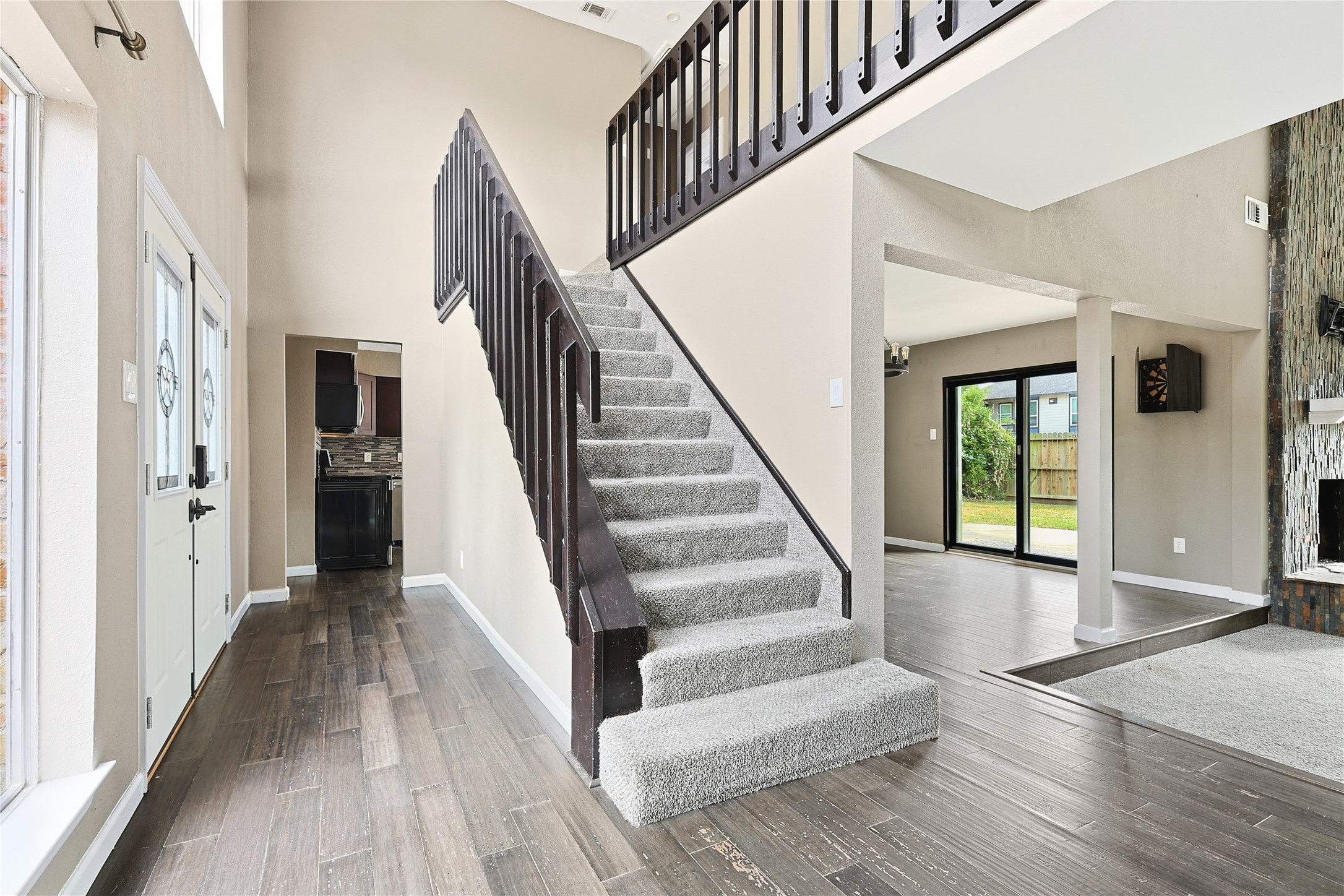 11727 Gardenglen Drive Cypress, TX 77429 - Photo 7 of 38 a view of staircase with lots of frames on wall and wooden floor