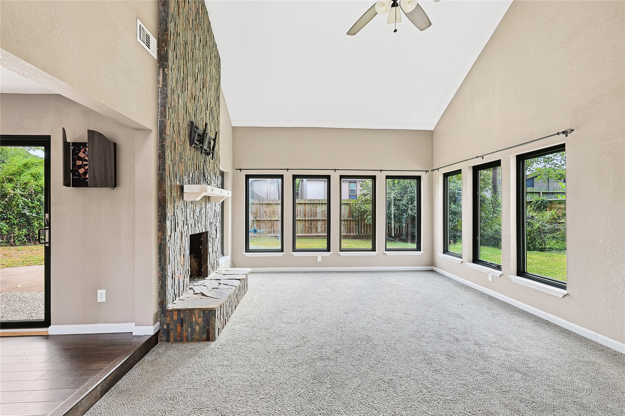 11727 Gardenglen Drive Cypress, TX 77429 - Photo 9 of 38 a view of an empty room with a fireplace and a window