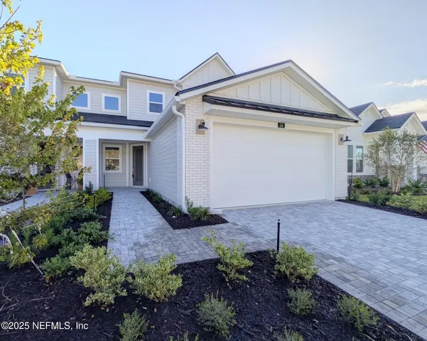 a view of a house with a yard and plants