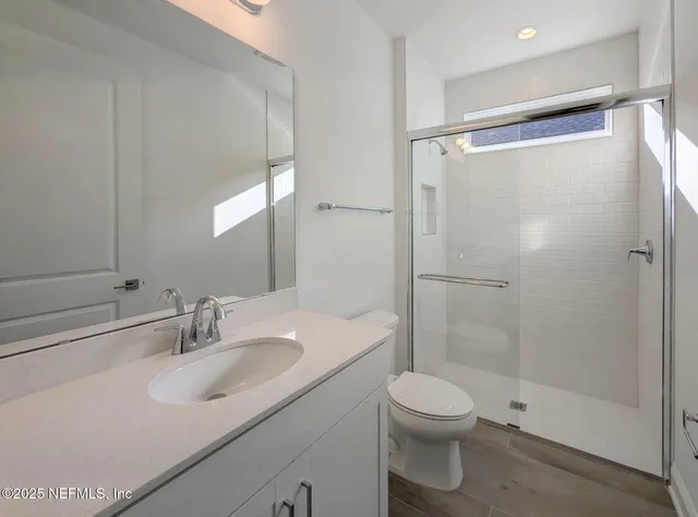 a bathroom with a sink toilet and shower