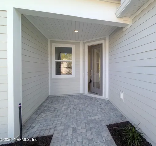 a view of a hallway with wooden walls and windows