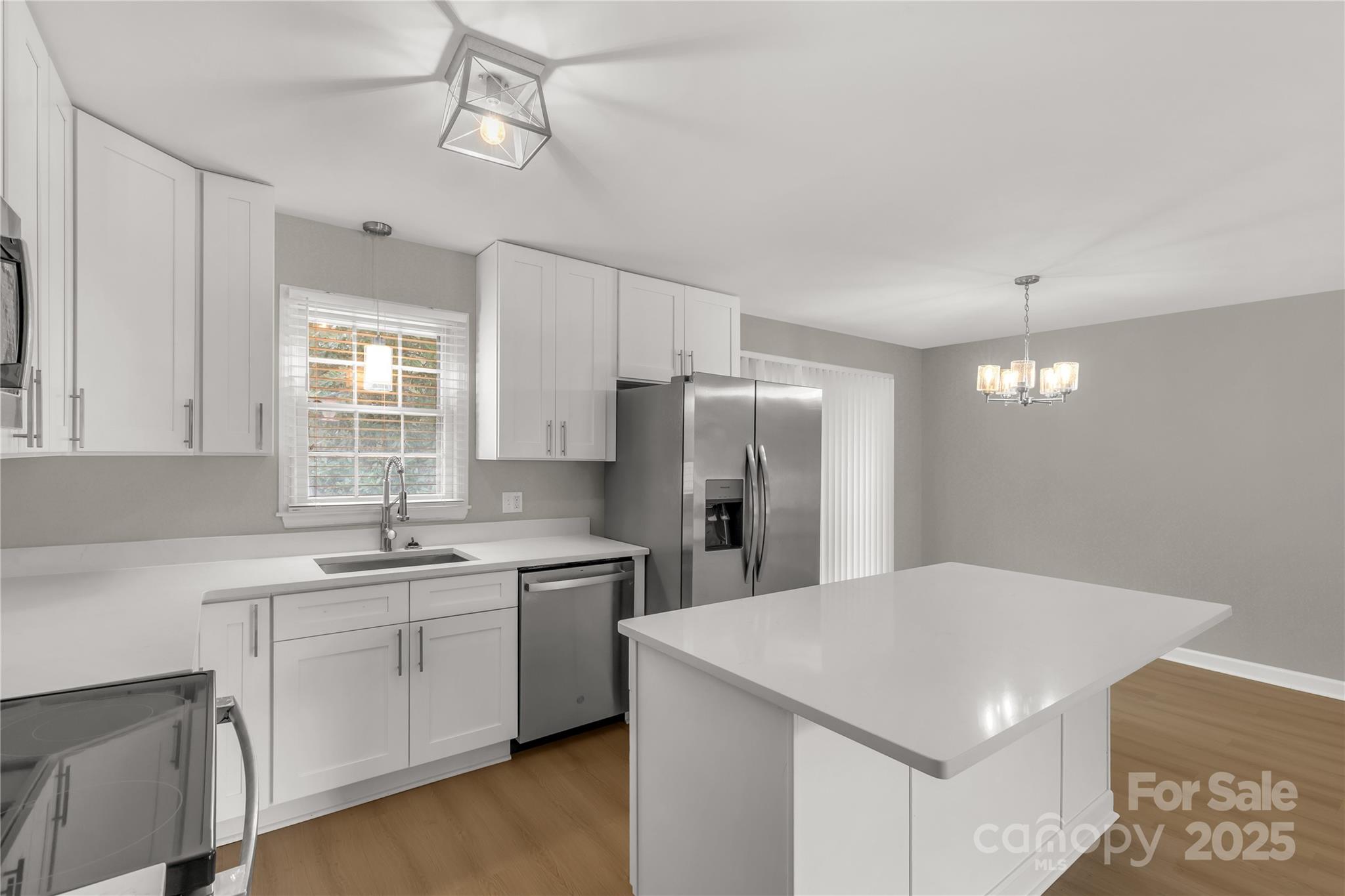 2220 Ross Cauthen Road Lancaster, SC 29720 - Photo 11 of 29 a kitchen with a white center island a sink cabinets and stainless steel appliances