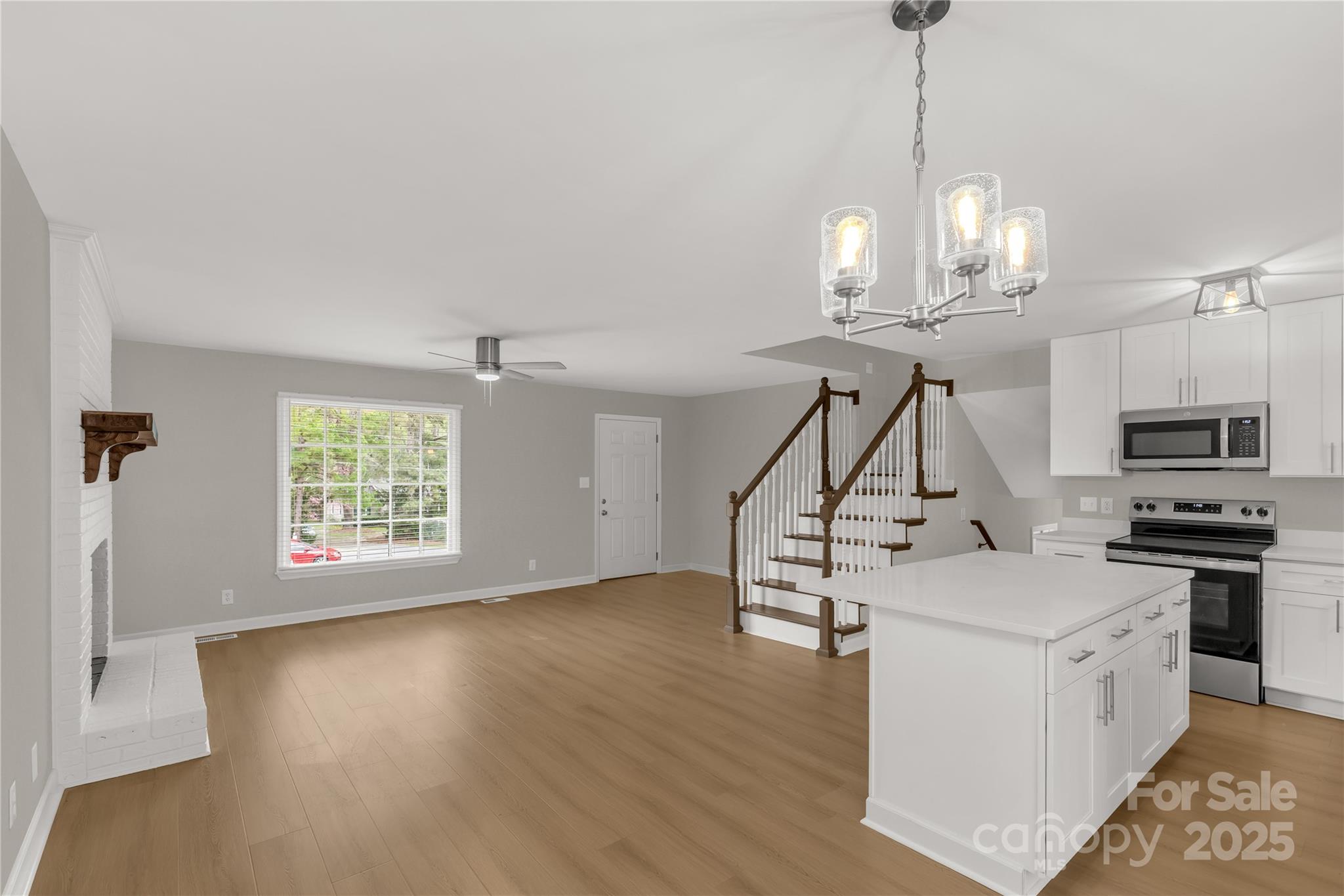 2220 Ross Cauthen Road Lancaster, SC 29720 - Photo 15 of 29 a view of a livingroom with furniture wooden floor windows and a chandelier