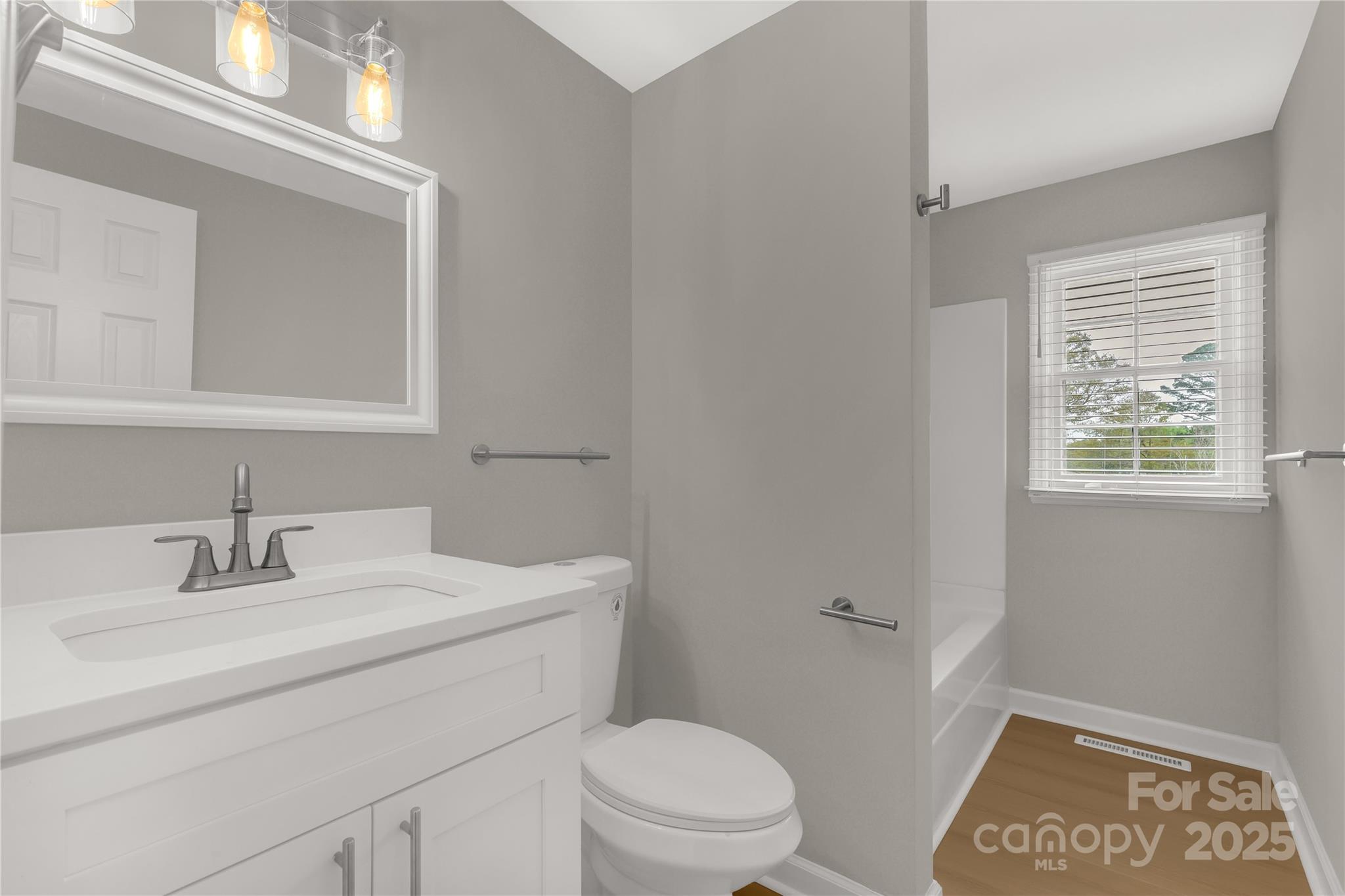 2220 Ross Cauthen Road Lancaster, SC 29720 - Photo 20 of 29 a bathroom with a sink a toilet and vanity