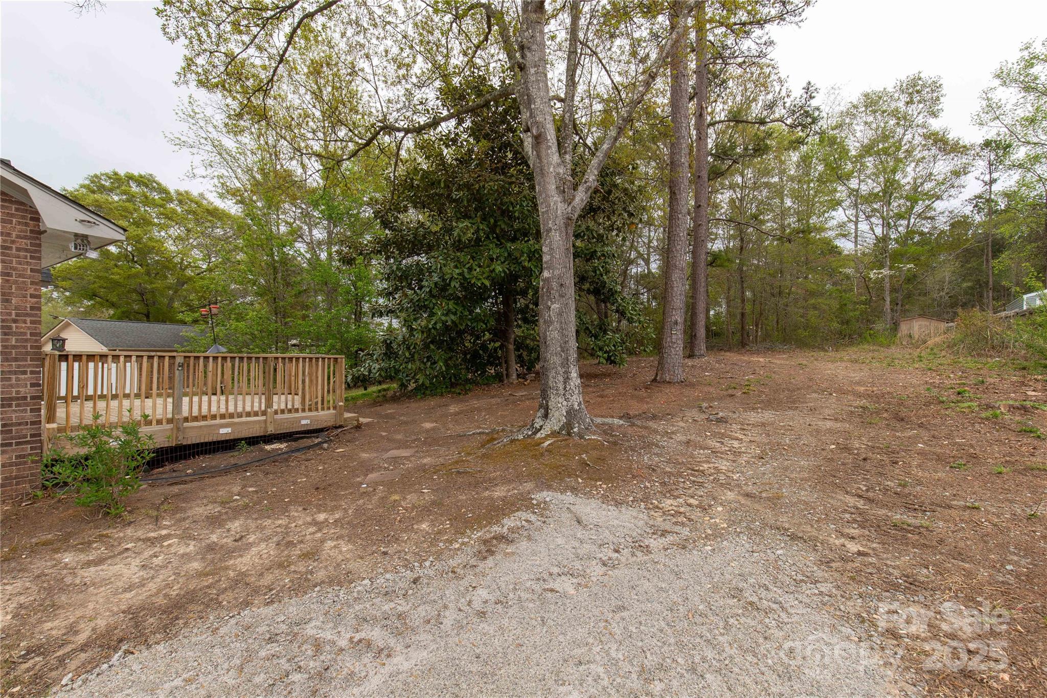 2220 Ross Cauthen Road Lancaster, SC 29720 - Photo 25 of 29 a view of a yard with large trees and wooden fence