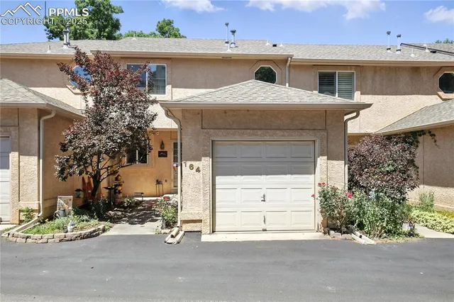 a view of a house with a yard and garage