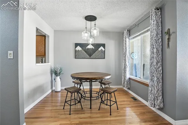 a view of a dining room with furniture window and wooden floor