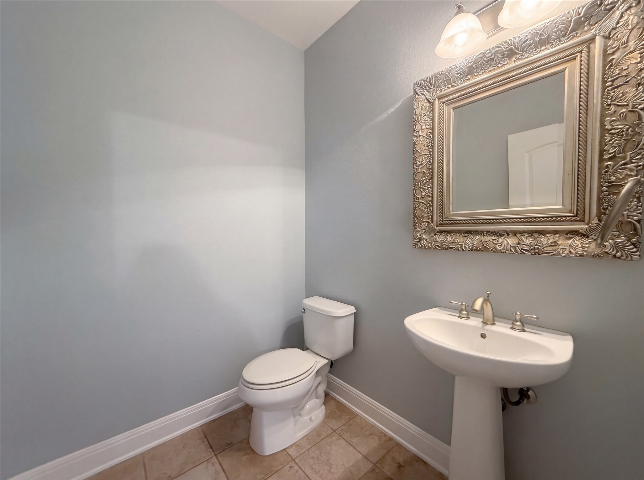 104 Perpetuation Drive Austin, TX 78734 - Photo 10 of 29 Half bath with baseboards and light tile patterned floors