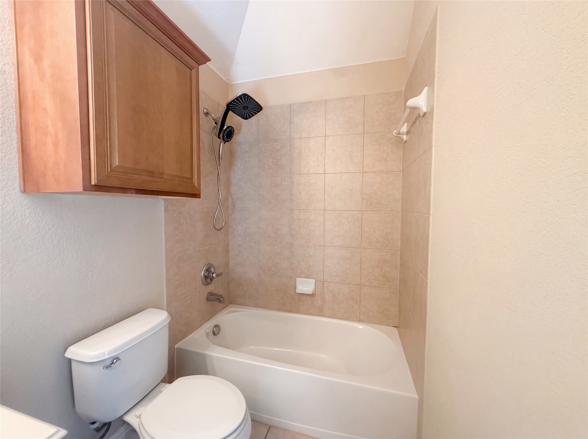 104 Perpetuation Drive Austin, TX 78734 - Photo 16 of 29 Bathroom featuring shower / washtub combination and a textured wall