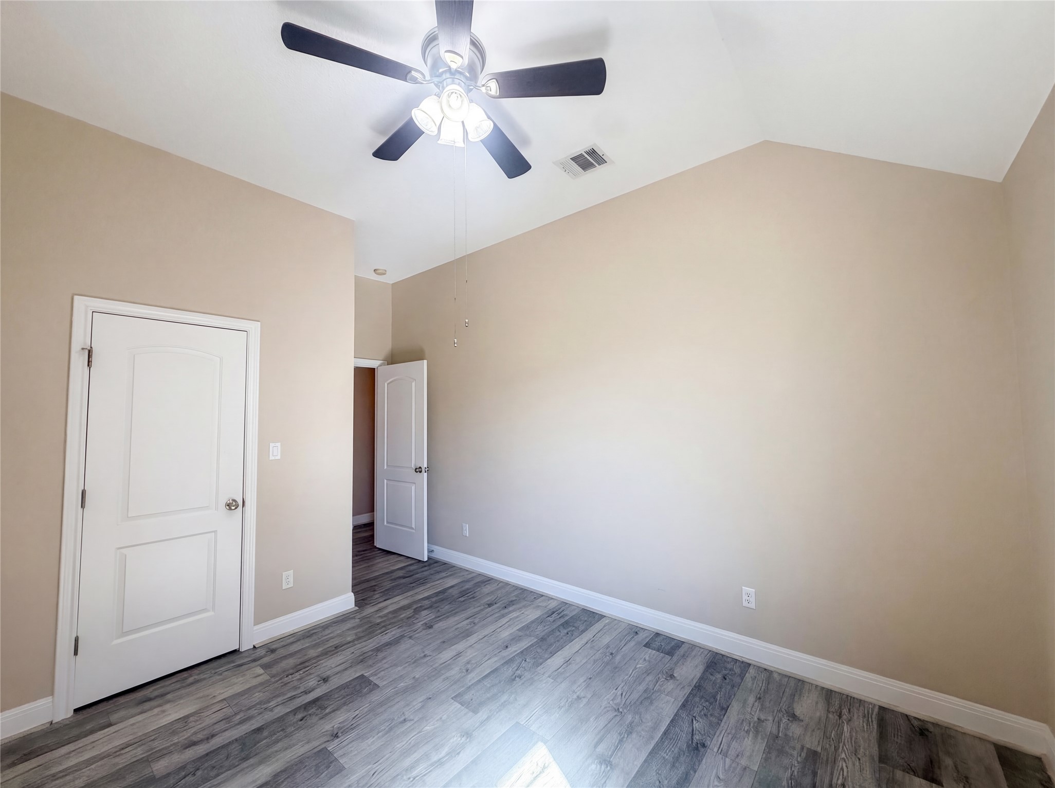 104 Perpetuation Drive Austin, TX 78734 - Photo 20 of 29 Unfurnished bedroom featuring lofted ceiling, light wood finished floors, and ceiling fan