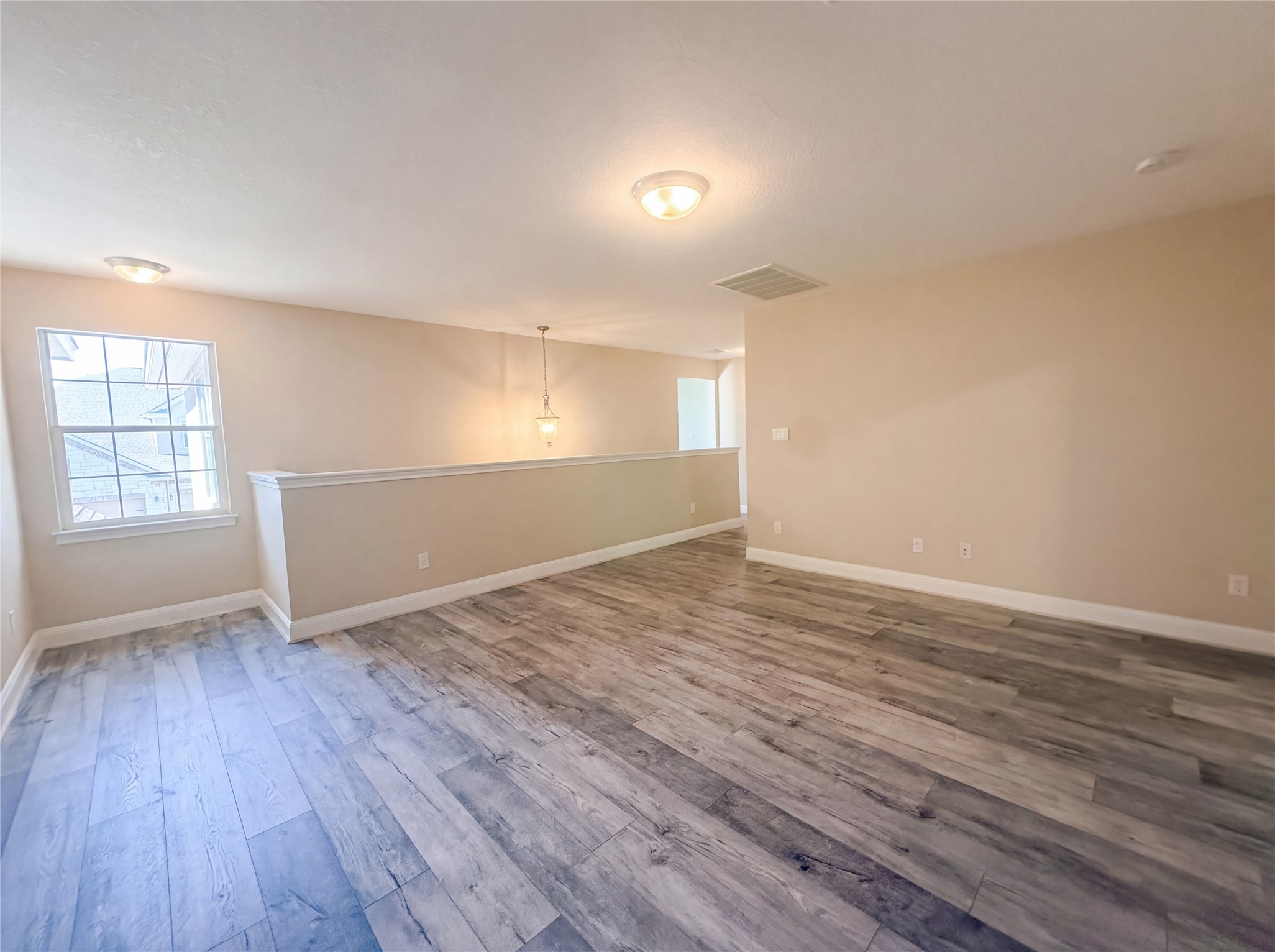 104 Perpetuation Drive Austin, TX 78734 - Photo 22 of 29 Unfurnished room featuring light wood-style flooring and plenty of natural light