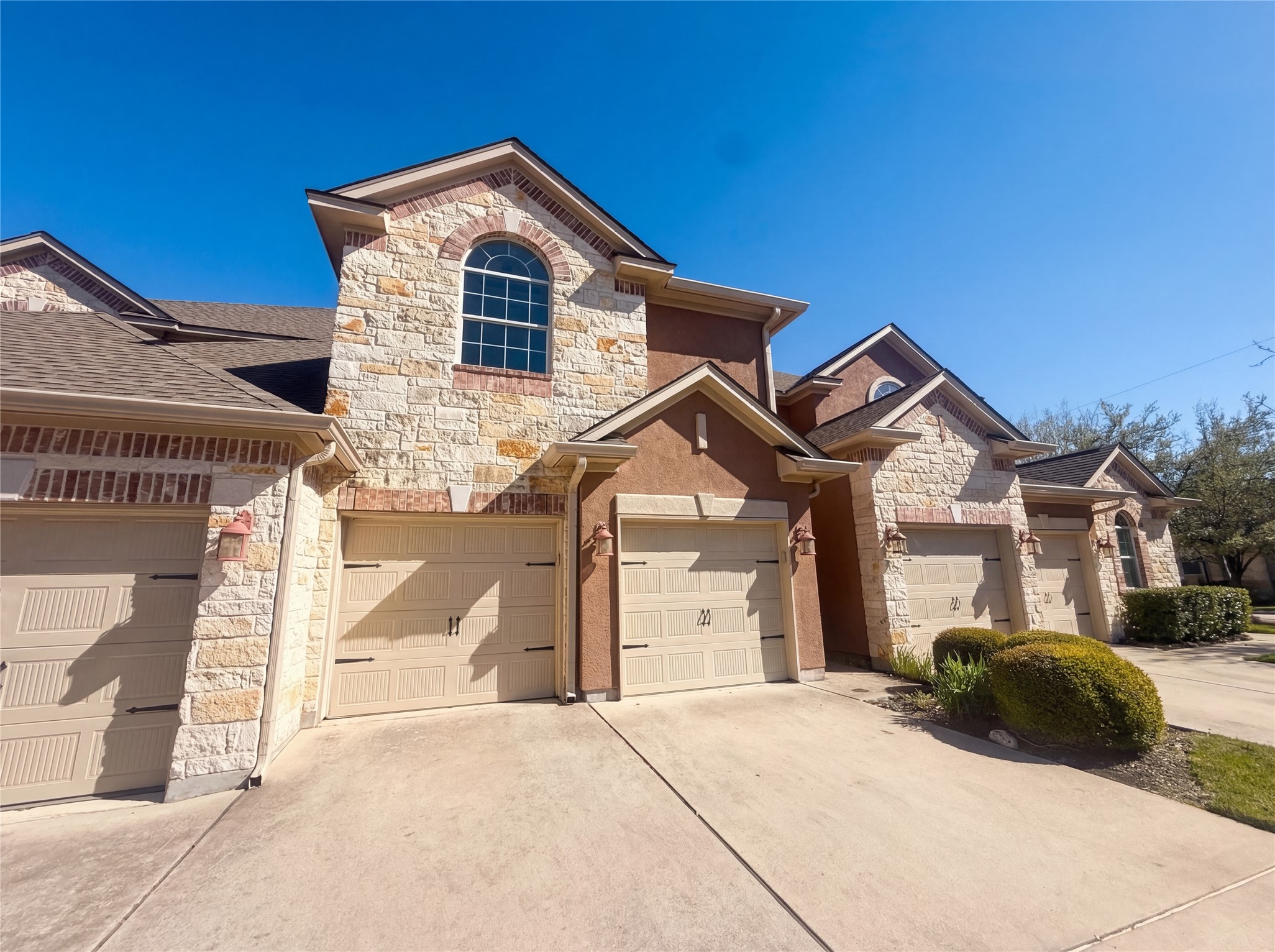 104 Perpetuation Drive Austin, TX 78734 - Photo 26 of 29 French country style house featuring stone siding, concrete driveway, and a garage