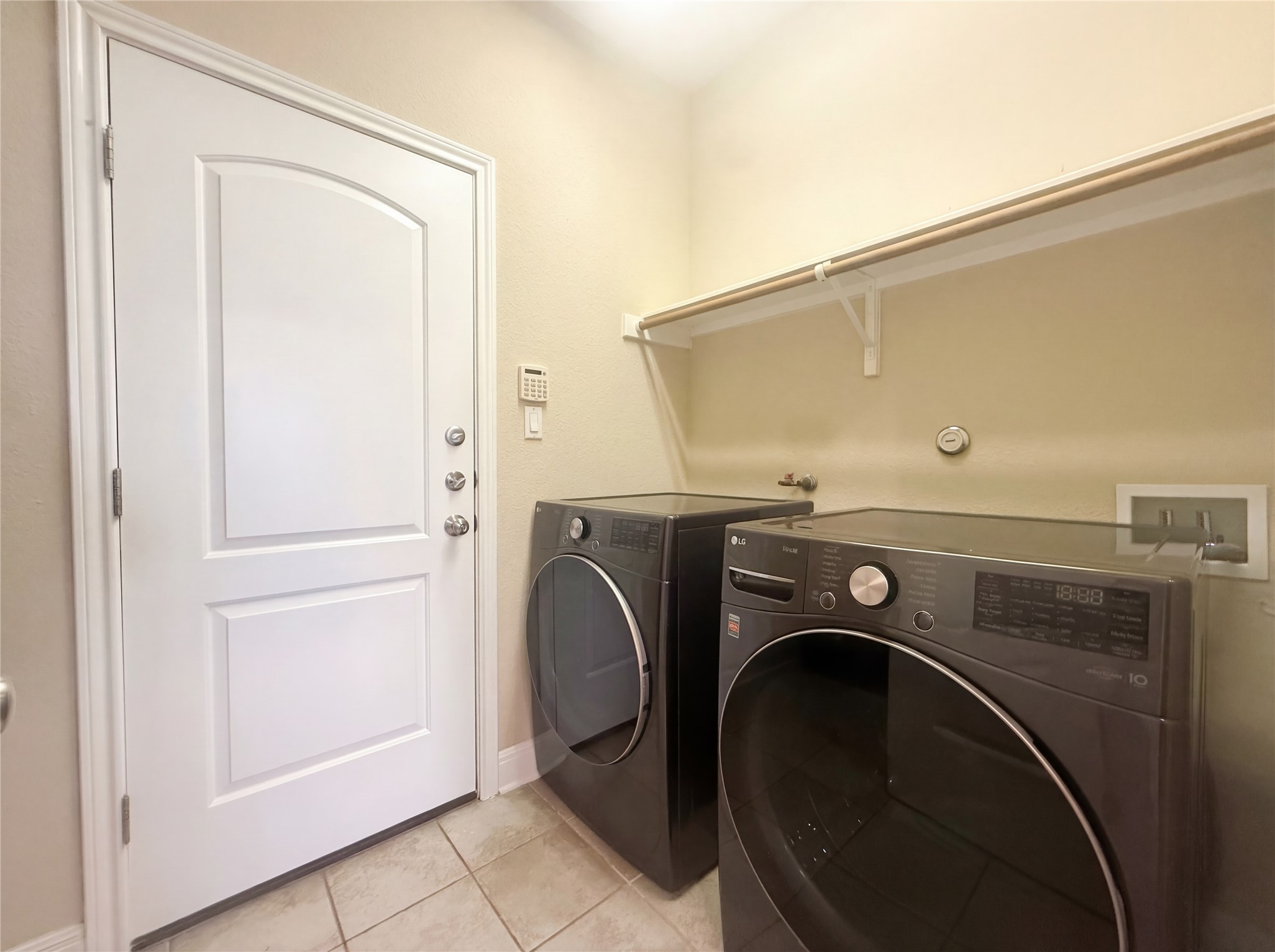 104 Perpetuation Drive Austin, TX 78734 - Photo 9 of 29 Laundry room featuring light tile patterned floors and separate washer and dryer