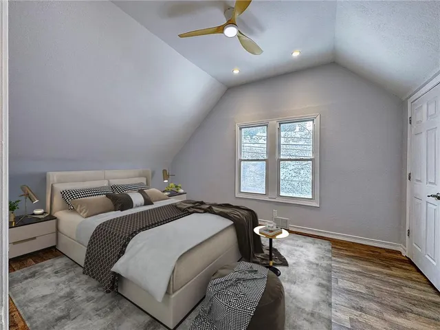 a spacious bedroom with a bed and a window