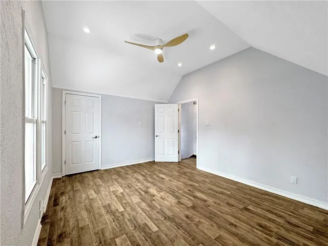 a view of a livingroom with a ceiling fan and wooden floor