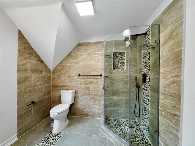 a bathroom with a toilet and a shower