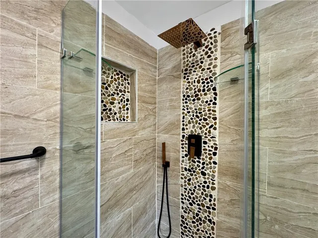 a bathroom with a shower and a shower