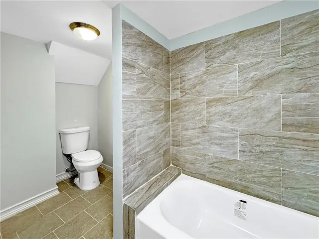 a bathroom with a toilet and a bathtub