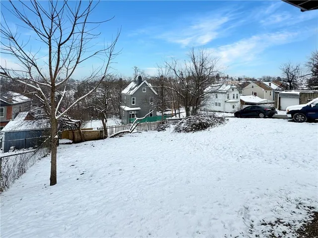 a front view of a house with basket ball court