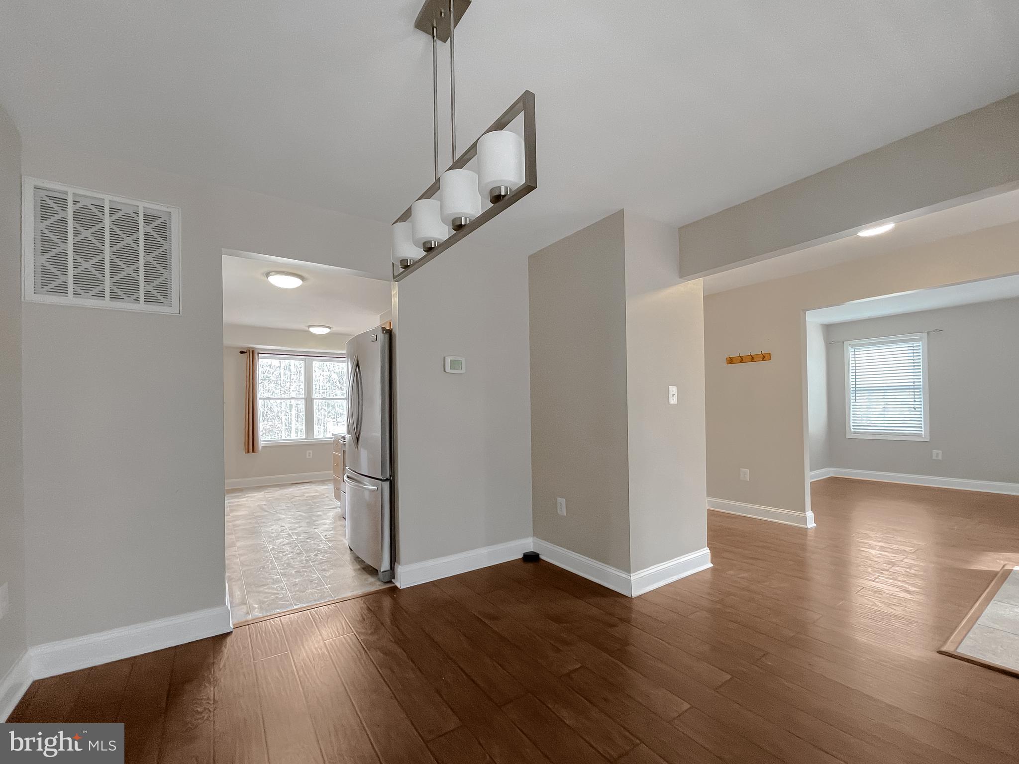 12968 Sailboat Lane Lusby, MD 20657 - Photo 13 of 57 a view of empty room with wooden floor and window
