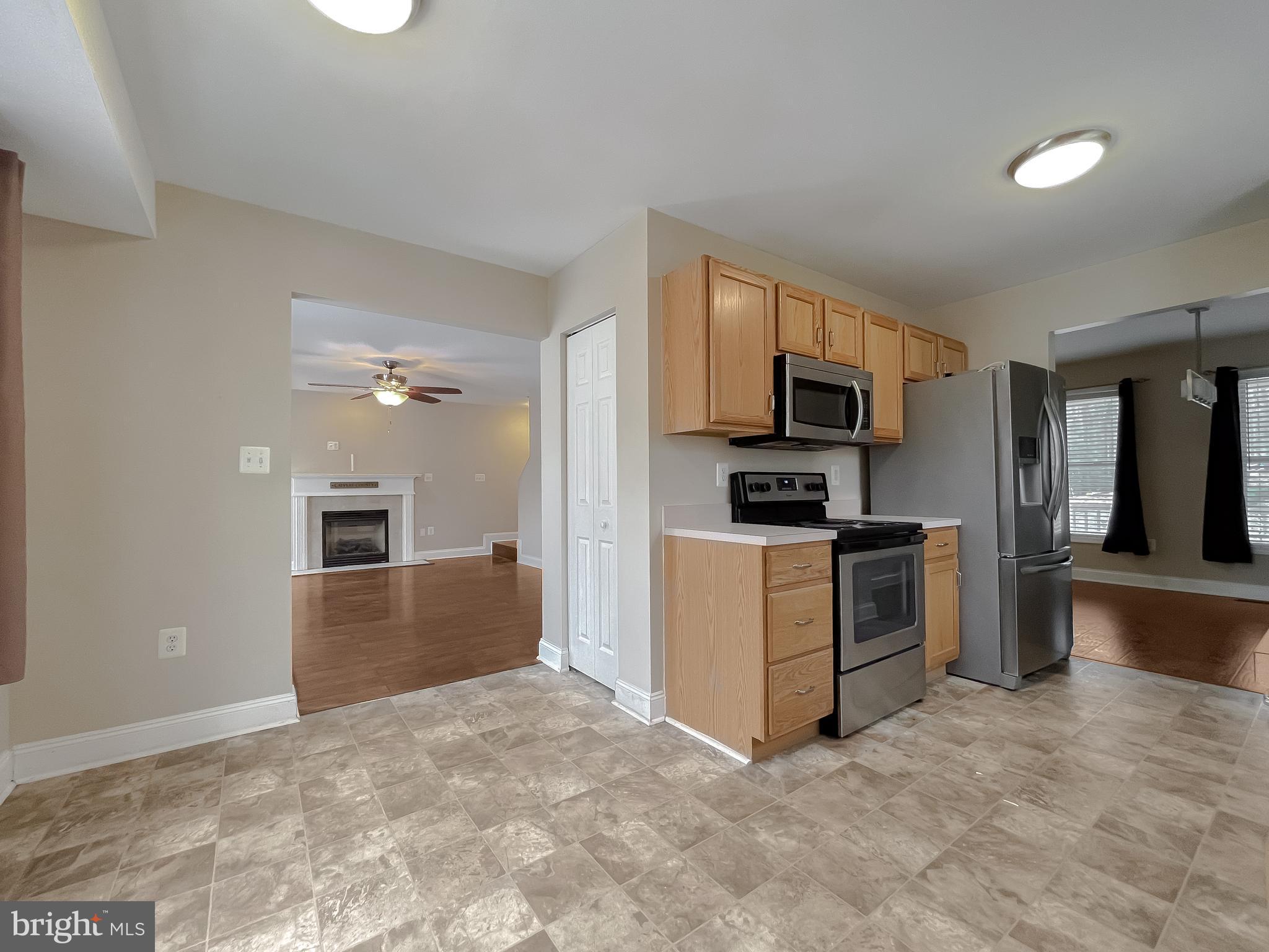 12968 Sailboat Lane Lusby, MD 20657 - Photo 17 of 57 a kitchen with granite countertop a stove top oven and refrigerator