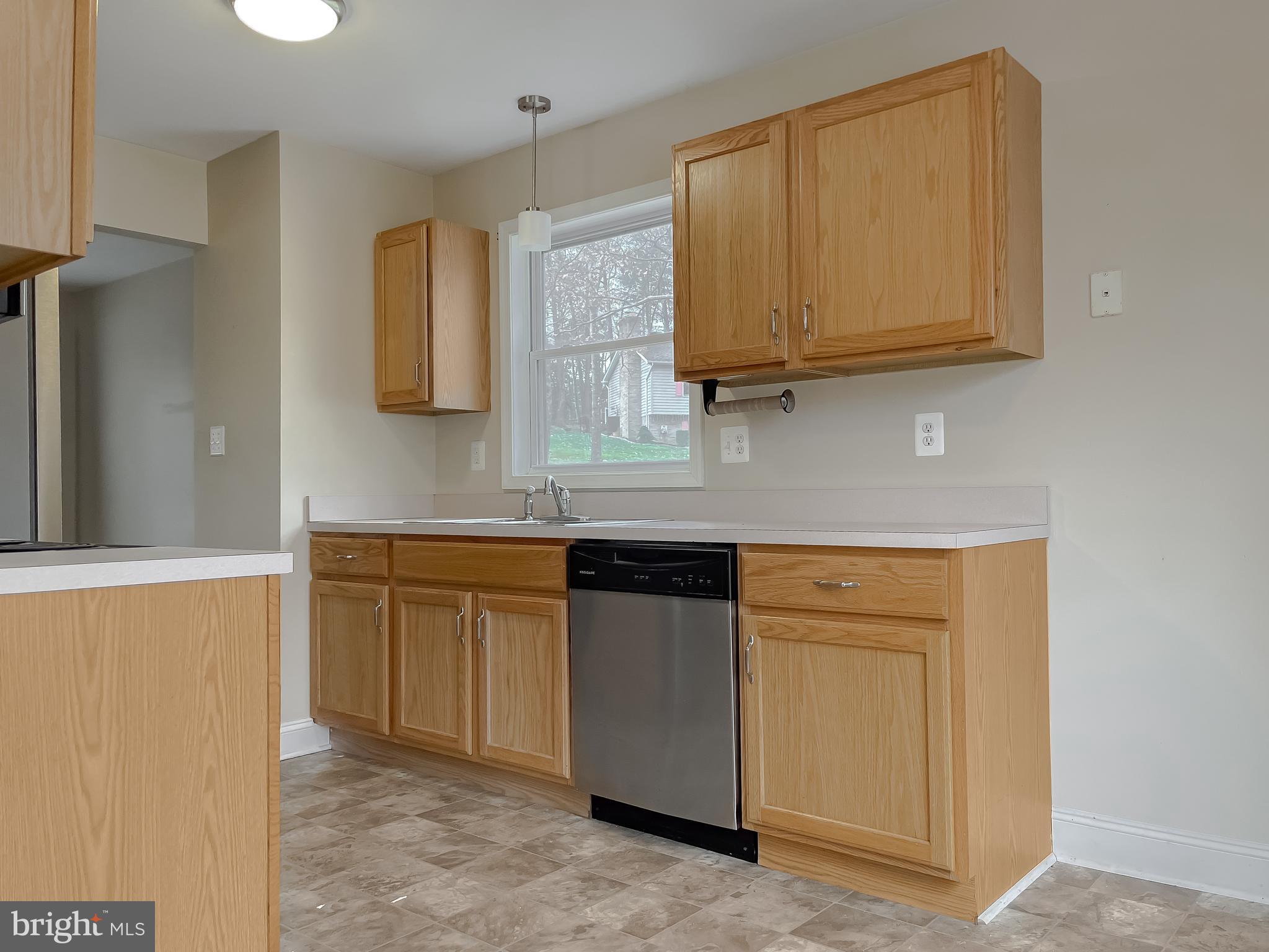 12968 Sailboat Lane Lusby, MD 20657 - Photo 20 of 57 a kitchen with stainless steel appliances granite countertop a sink and cabinets