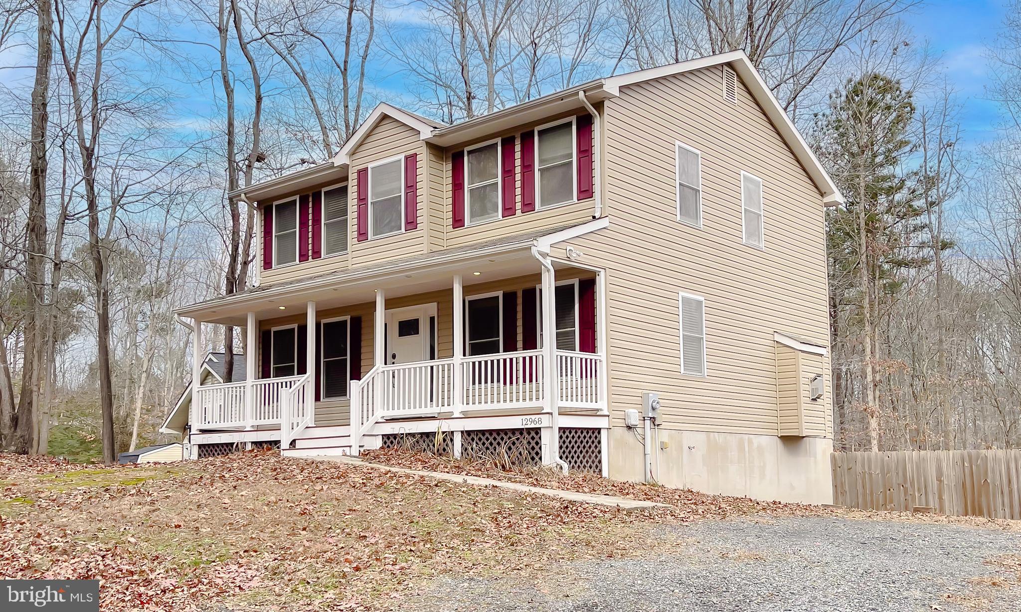 12968 Sailboat Lane Lusby, MD 20657 - Photo 2 of 57 a house with large windows and wooden fence