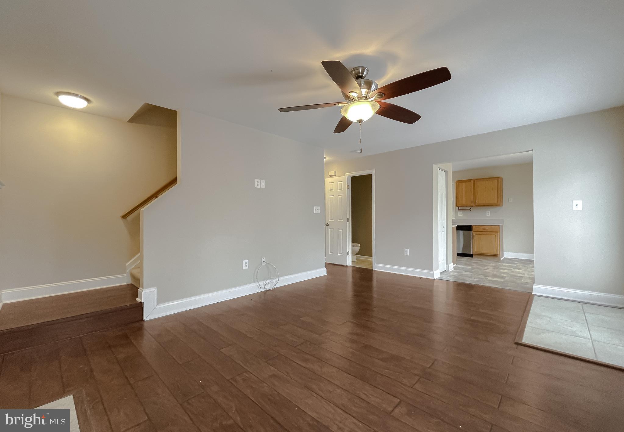 12968 Sailboat Lane Lusby, MD 20657 - Photo 26 of 57 a view of an empty room with wooden floor and a ceiling fan