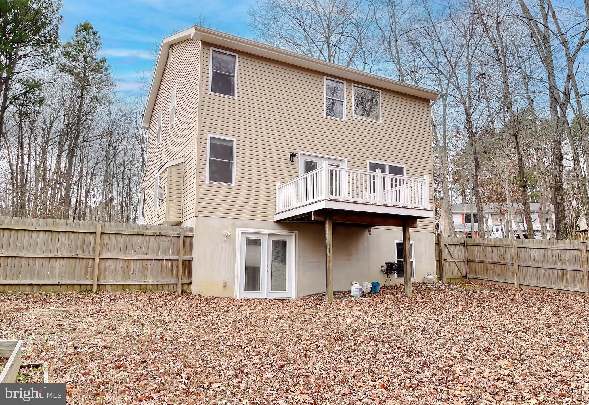 12968 Sailboat Lane Lusby, MD 20657 - Photo 51 of 57 a front view of a house with a yard