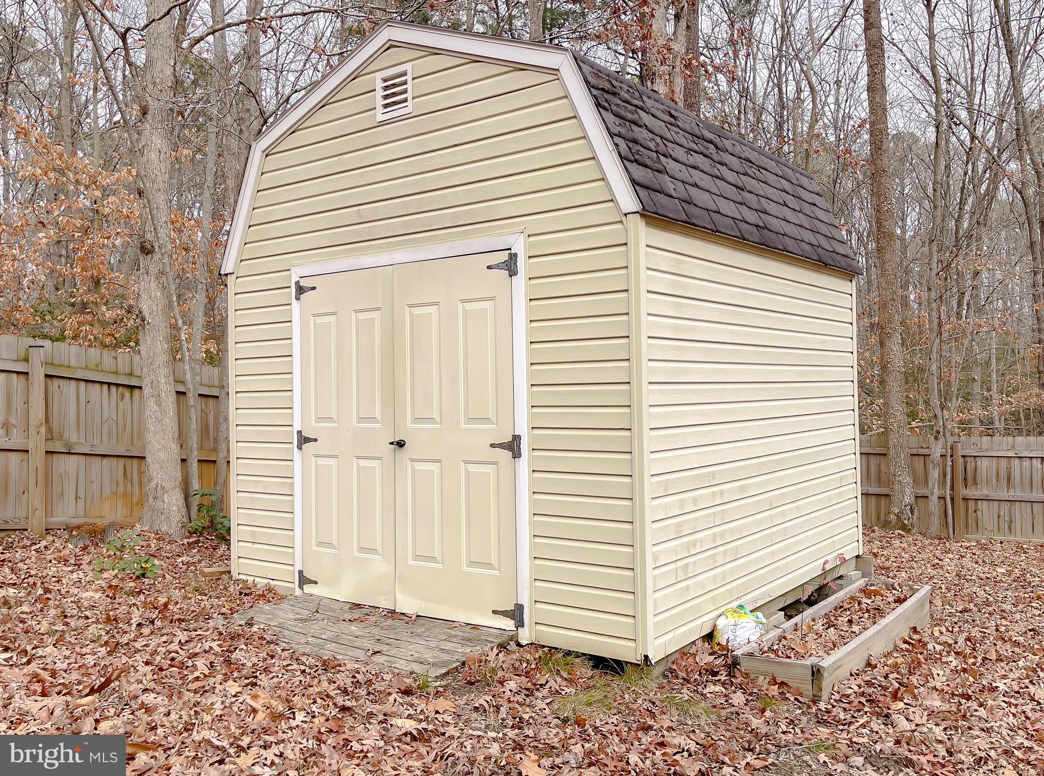 12968 Sailboat Lane Lusby, MD 20657 - Photo 57 of 57 a view of a house with a yard and garage
