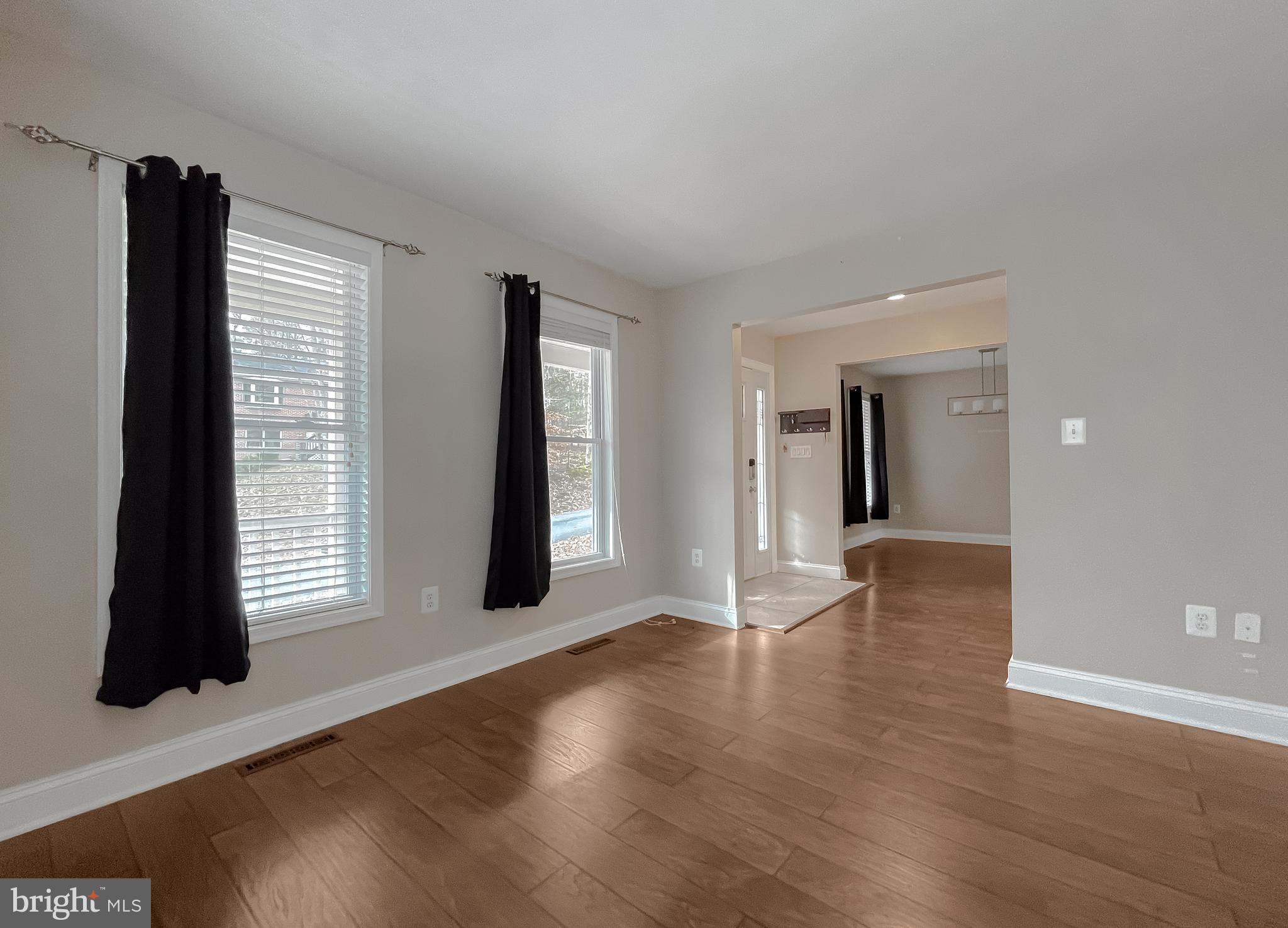 12968 Sailboat Lane Lusby, MD 20657 - Photo 7 of 57 a view of an empty room with wooden floor and a window