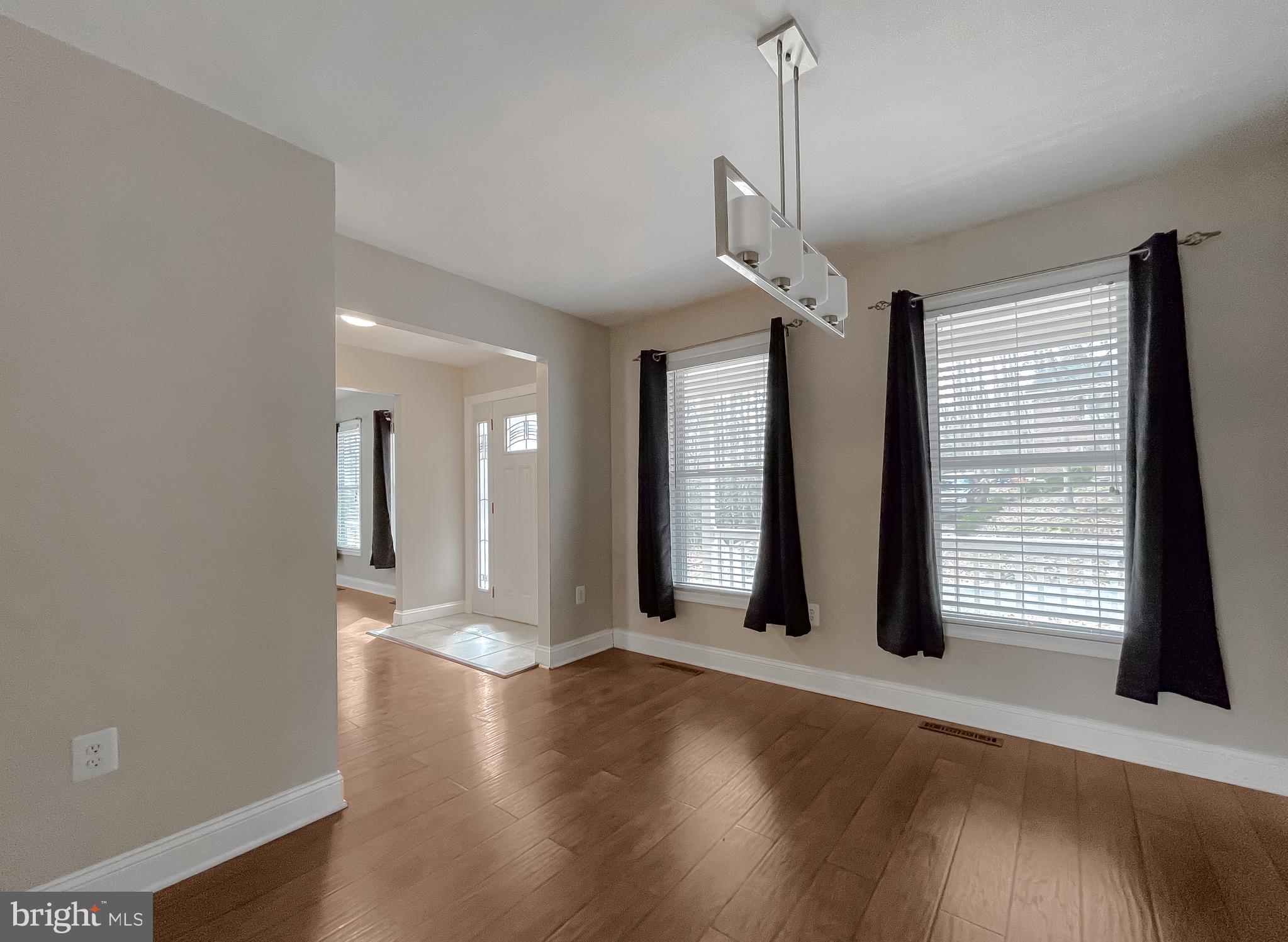 12968 Sailboat Lane Lusby, MD 20657 - Photo 10 of 57 a view of a room with wooden floor and large window