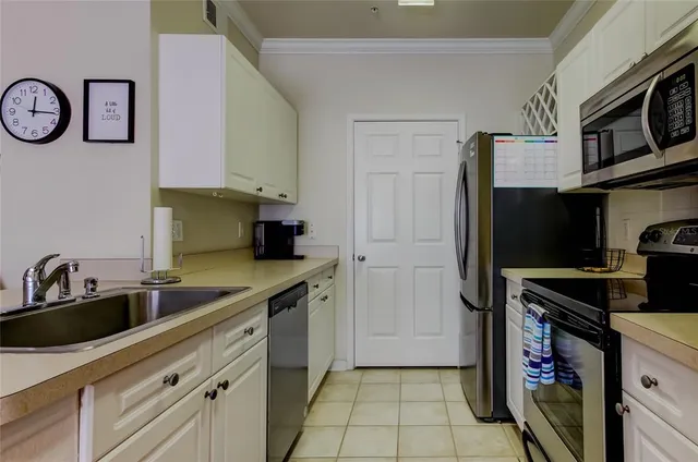 a kitchen with stainless steel appliances a refrigerator and a stove top oven