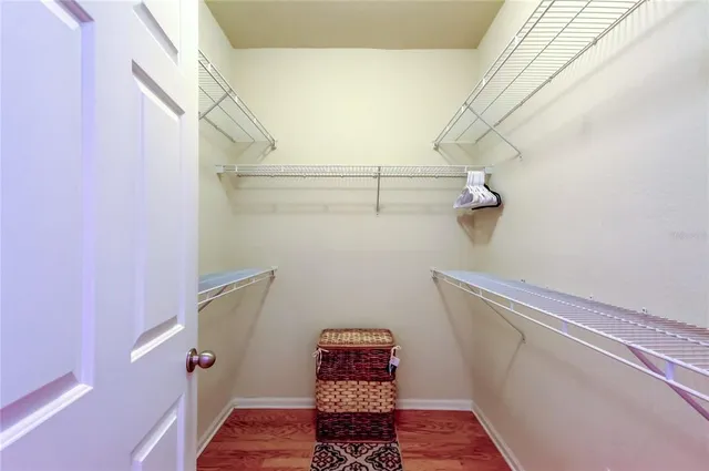 a living room with a couch and a lamp on a bookshelf