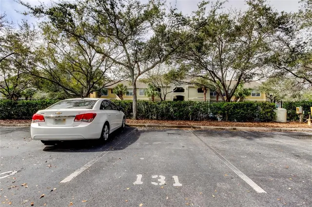 an aerial view of a house with a yard and large trees