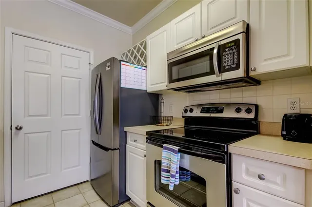 a kitchen with stainless steel appliances a sink cabinets and wooden floor