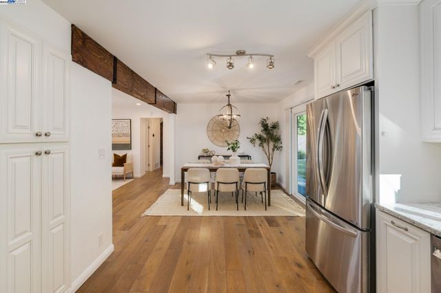 a kitchen with stainless steel appliances granite countertop a refrigerator and a stove top oven