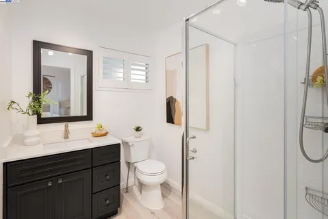 a bathroom with a toilet a sink and mirror