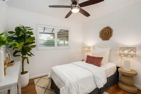 a bedroom with a bed and a potted plant